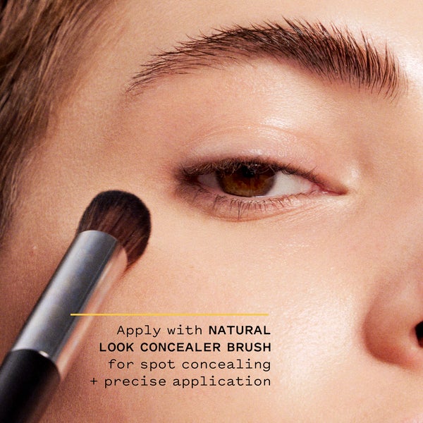 Model applying concealer tint with natural look concealer brush